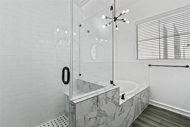 2100 N Fitzhugh Ave Unit D, Dallas, TX 75204 - bathroom featuring a stall shower, a bath, a chandelier, baseboards, and wood finished floors