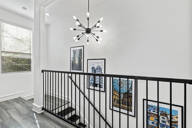 2100 N Fitzhugh Ave Unit D, Dallas, TX 75204 - hallway featuring a chandelier, an upstairs landing, wood finished floors, and baseboards
