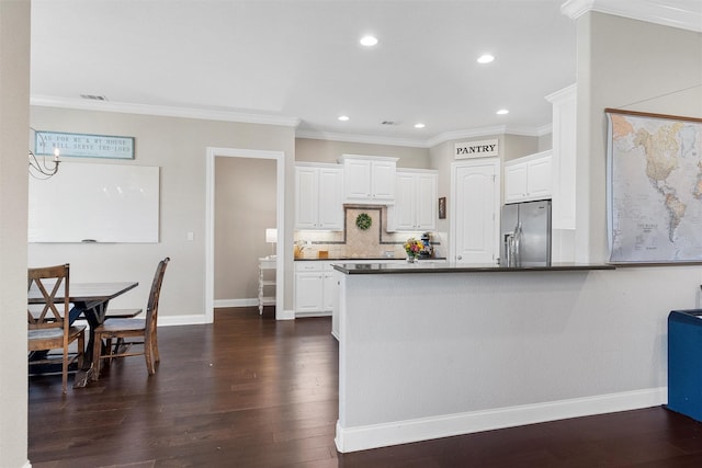 41 N Shore Cir, Waco, TX 76708 - kitchen with stainless steel fridge with ice dispenser, white cabinetry, dark wood finished floors, dark countertops, and tasteful backsplash