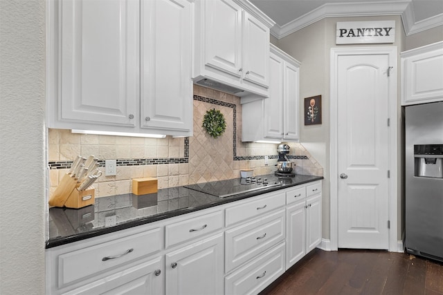 41 N Shore Cir, Waco, TX 76708 - kitchen with stainless steel refrigerator with ice dispenser, black electric cooktop, crown molding, white cabinets, and dark wood-style flooring