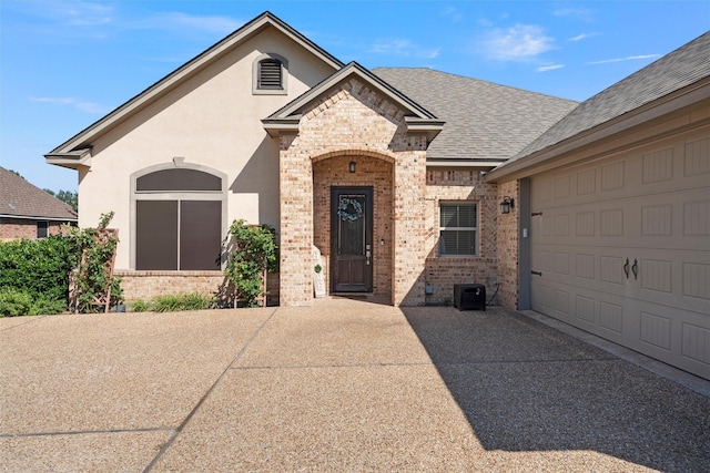 41 N Shore Cir, Waco, TX 76708 - french provincial home with brick siding, concrete driveway, roof with shingles, and cooling unit