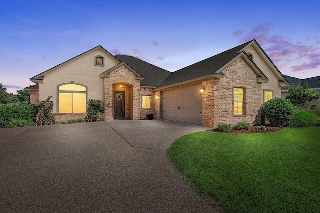 41 N Shore Cir, Waco, TX 76708 - view of front facade with a garage, brick siding, a front lawn, concrete driveway, and a shingled roof