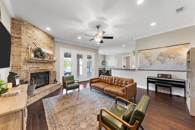 41 N Shore Cir, Waco, TX 76708 - living room featuring ceiling fan, crown molding, a fireplace, dark wood-style flooring, and recessed lighting