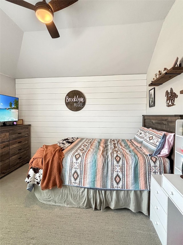 2219 Wellington Ln, Corinth, TX 76210 - carpeted bedroom featuring lofted ceiling, a ceiling fan, and wooden walls