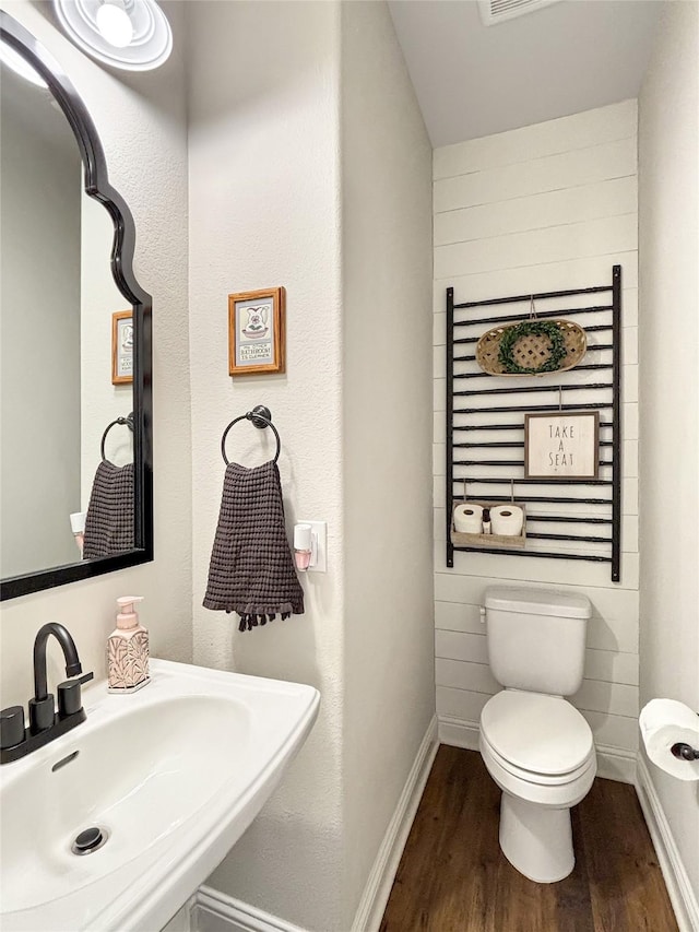 2219 Wellington Ln, Corinth, TX 76210 - bathroom featuring a sink, toilet, wood finished floors, and baseboards