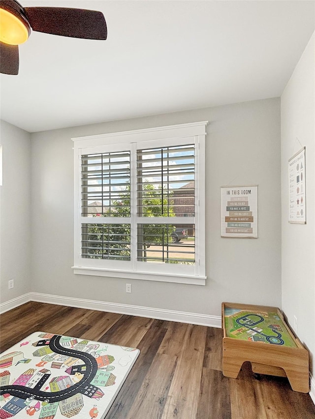 2219 Wellington Ln, Corinth, TX 76210 - recreation room with wood finished floors, baseboards, and a ceiling fan