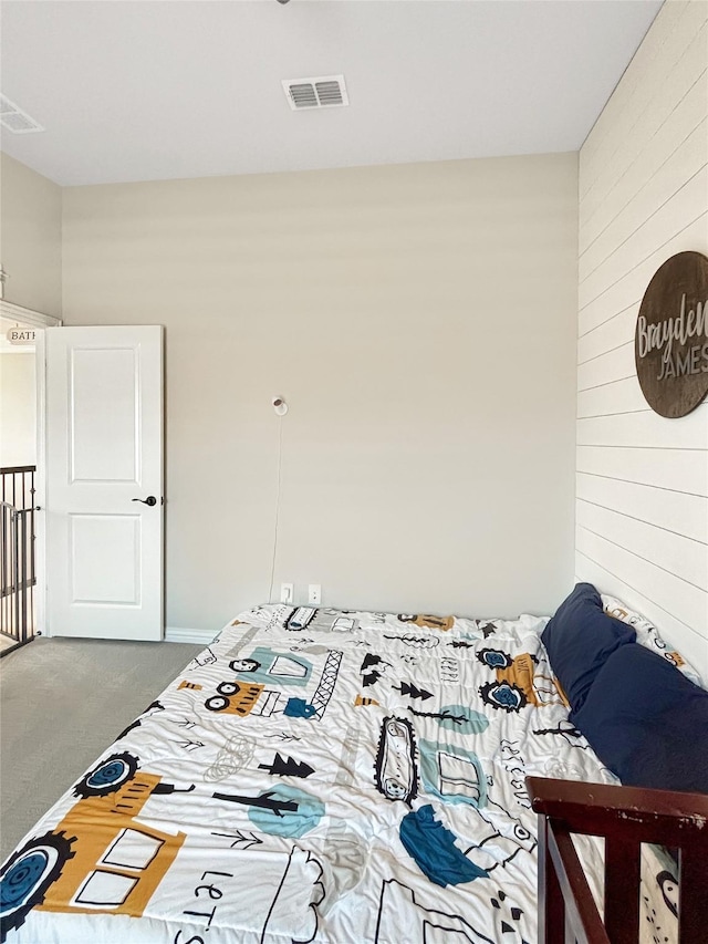 2219 Wellington Ln, Corinth, TX 76210 - bedroom with carpet floors and wood walls