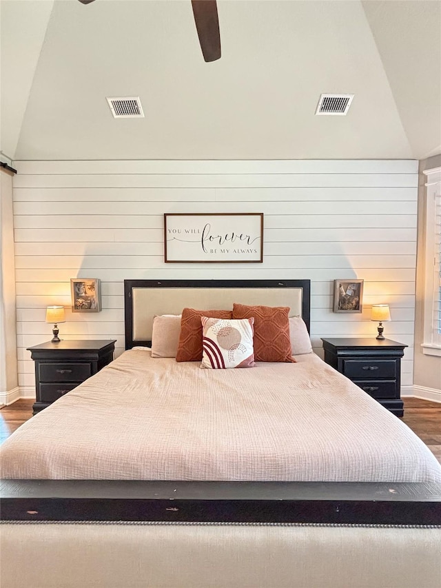 2219 Wellington Ln, Corinth, TX 76210 - bedroom featuring vaulted ceiling, dark wood-style flooring, baseboards, wooden walls, and ceiling fan