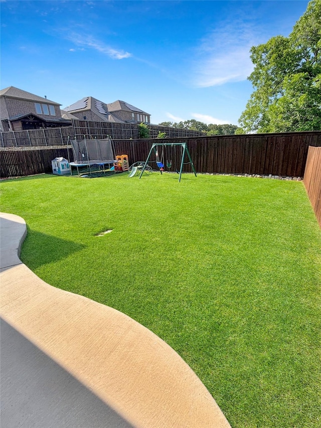 2219 Wellington Ln, Corinth, TX 76210 - view of yard featuring a trampoline and a playground