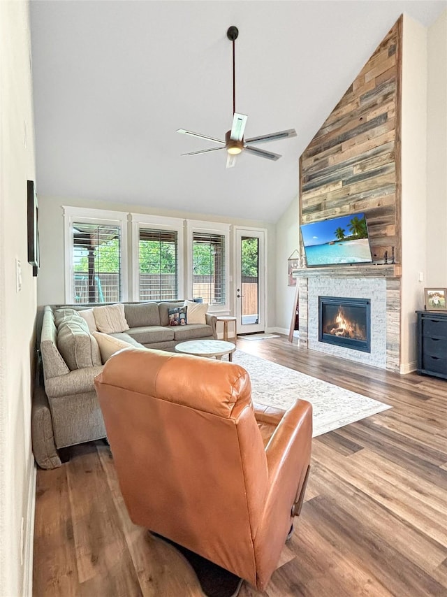 2219 Wellington Ln, Corinth, TX 76210 - living area with high vaulted ceiling, plenty of natural light, a ceiling fan, wood finished floors, and a stone fireplace