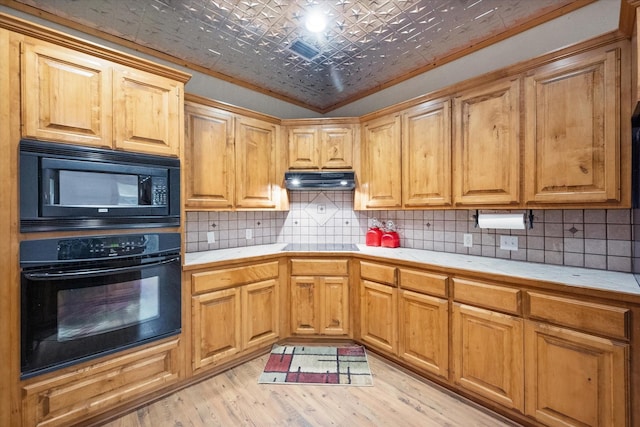108 Fcr 868, Teague, TX 75860 - kitchen with black appliances, an ornate ceiling, tile counters, light wood-style floors, and backsplash