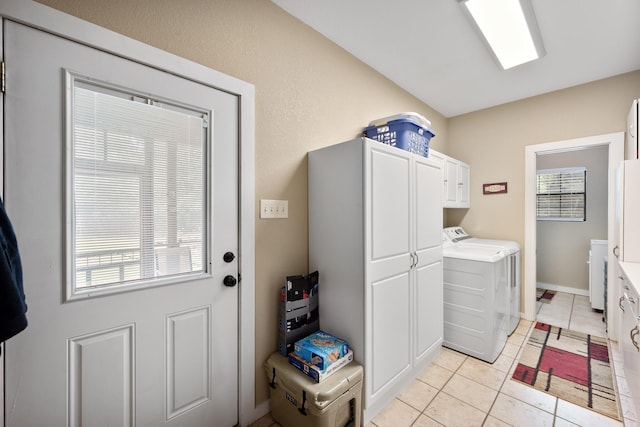 108 Fcr 868, Teague, TX 75860 - washroom with washing machine and clothes dryer, cabinet space, and light tile patterned floors