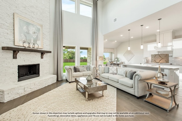3416 Running Stream Way, Melissa, TX 75454 - living area featuring a towering ceiling, wood finished floors, a stone fireplace, and recessed lighting
