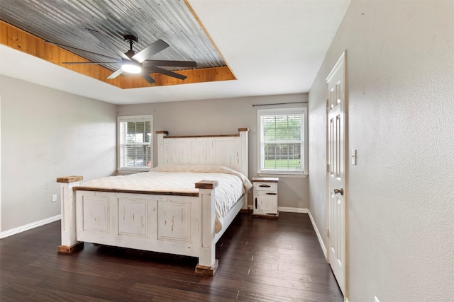 110 Harmon Cir, Blue Ridge, TX 75424 - bedroom featuring multiple windows, baseboards, dark wood-style flooring, and a ceiling fan