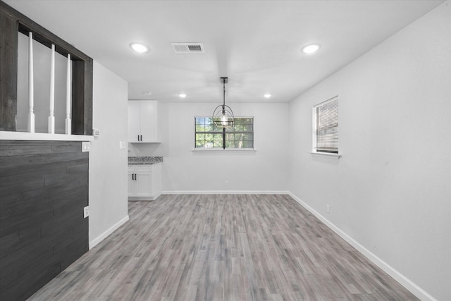 1312 E Collin, Corsicana, TX 75110 - unfurnished dining area with baseboards, light wood-type flooring, and recessed lighting