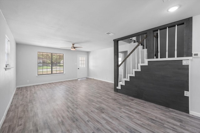 1312 E Collin, Corsicana, TX 75110 - unfurnished living room featuring wood finished floors, stairway, a ceiling fan, and baseboards