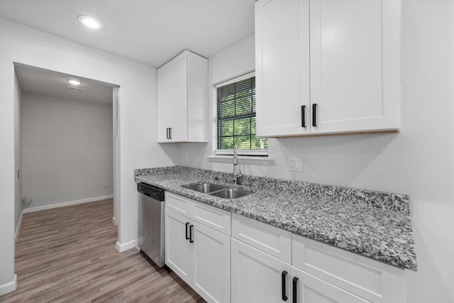 1312 E Collin, Corsicana, TX 75110 - kitchen with a sink, stainless steel dishwasher, baseboards, white cabinetry, and recessed lighting
