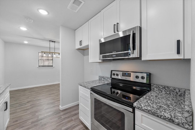 1312 E Collin, Corsicana, TX 75110 - kitchen featuring stainless steel appliances, baseboards, white cabinetry, light stone counters, and recessed lighting