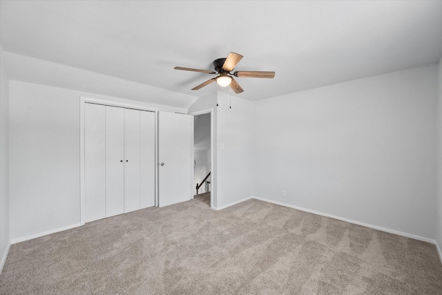 1312 E Collin, Corsicana, TX 75110 - unfurnished bedroom featuring carpet, a closet, a ceiling fan, baseboards, and lofted ceiling