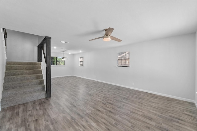 1312 E Collin, Corsicana, TX 75110 - unfurnished living room with stairway, wood finished floors, baseboards, a ceiling fan, and recessed lighting