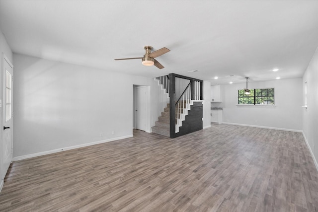 1312 E Collin, Corsicana, TX 75110 - unfurnished living room featuring stairway, ceiling fan, wood finished floors, baseboards, and recessed lighting