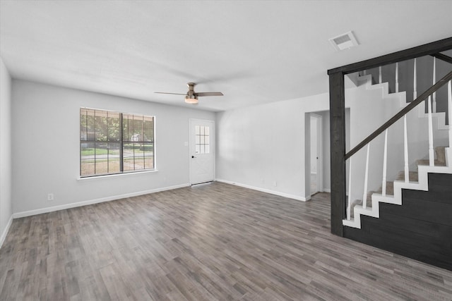 1312 E Collin, Corsicana, TX 75110 - unfurnished living room featuring stairs, wood finished floors, ceiling fan, and baseboards