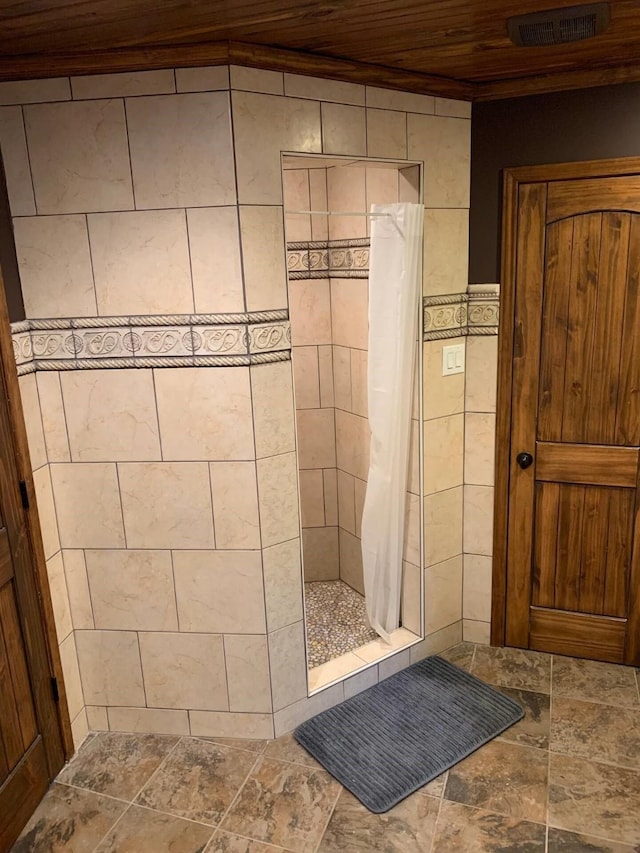 116 Summerall Dr, Mabank, TX 75156 - bathroom featuring wood ceiling, a stall shower, tile walls, and stone finish flooring