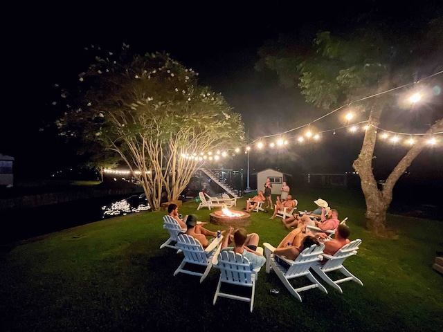 116 Summerall Dr, Mabank, TX 75156 - yard at night featuring an outdoor fire pit and a lawn