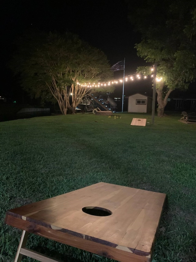 116 Summerall Dr, Mabank, TX 75156 - yard at night with a lawn and an outbuilding