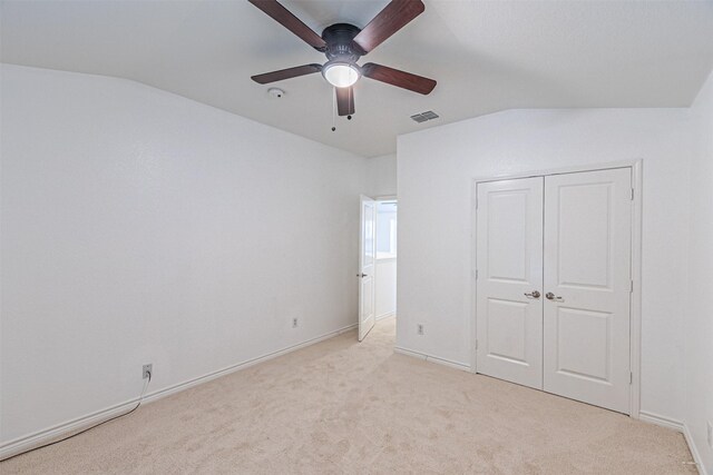 6547 Portside Ridge Ln, Dallas, TX 75249 - unfurnished bedroom with lofted ceiling, light colored carpet, baseboards, a closet, and a ceiling fan