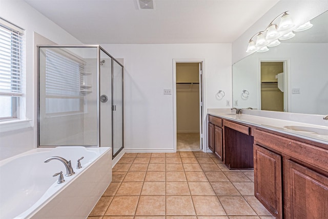 6547 Portside Ridge Ln, Dallas, TX 75249 - bathroom featuring a spacious closet, a shower stall, double vanity, a garden tub, and tile patterned flooring