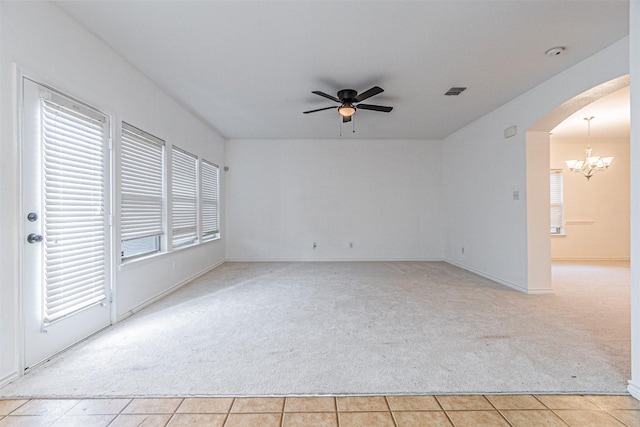 6547 Portside Ridge Ln, Dallas, TX 75249 - unfurnished room featuring light carpet, arched walkways, a ceiling fan, and a chandelier