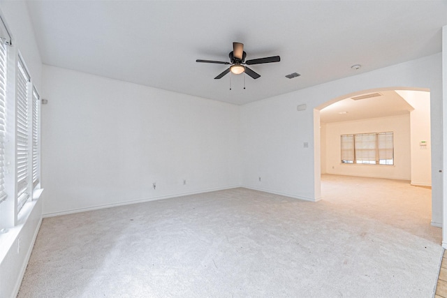 6547 Portside Ridge Ln, Dallas, TX 75249 - unfurnished room with ceiling fan, light colored carpet, arched walkways, and baseboards