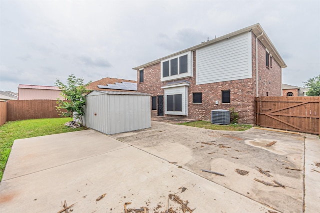 6547 Portside Ridge Ln, Dallas, TX 75249 - rear view of house featuring a patio, central air condition unit, brick siding, and a gate