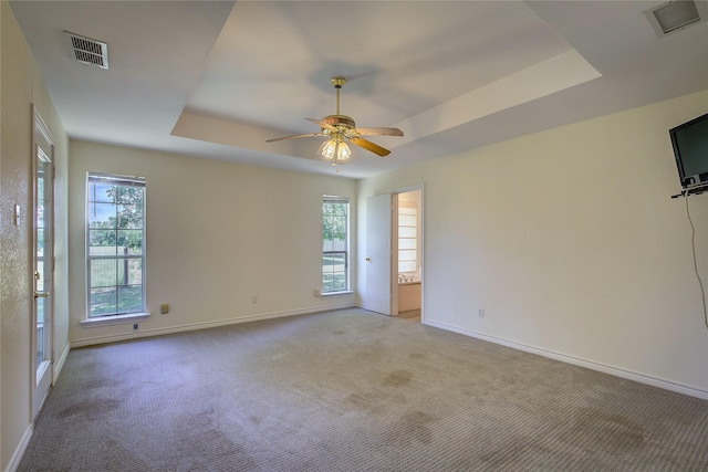5701 Fm 2101, Quinlan, TX 75474 - empty room with a raised ceiling, baseboards, plenty of natural light, and light colored carpet