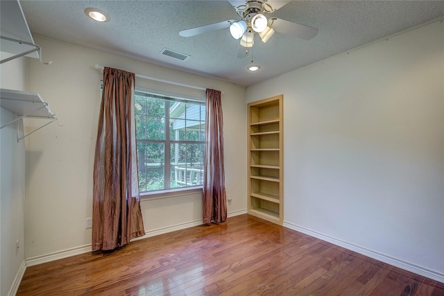5701 Fm 2101, Quinlan, TX 75474 - unfurnished room featuring wood finished floors, a textured ceiling, ceiling fan, baseboards, and recessed lighting