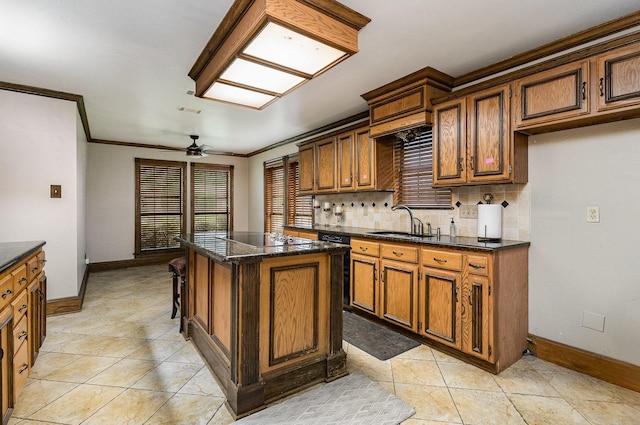 3313 Conlin Dr, Rowlett, TX 75088 - kitchen with a sink, baseboards, crown molding, ceiling fan, and a center island