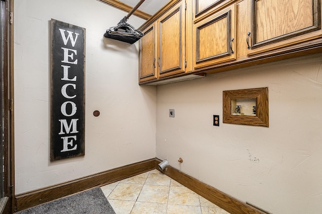 3313 Conlin Dr, Rowlett, TX 75088 - laundry area featuring hookup for a washing machine, cabinet space, light tile patterned floors, electric dryer hookup, and baseboards