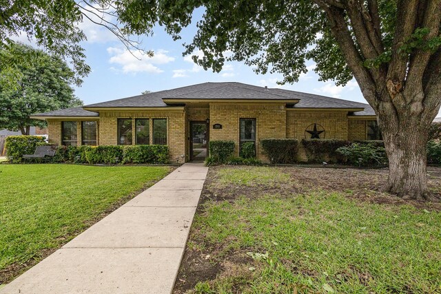3313 Conlin Dr, Rowlett, TX 75088 - view of front facade with brick siding, a front yard, and a shingled roof