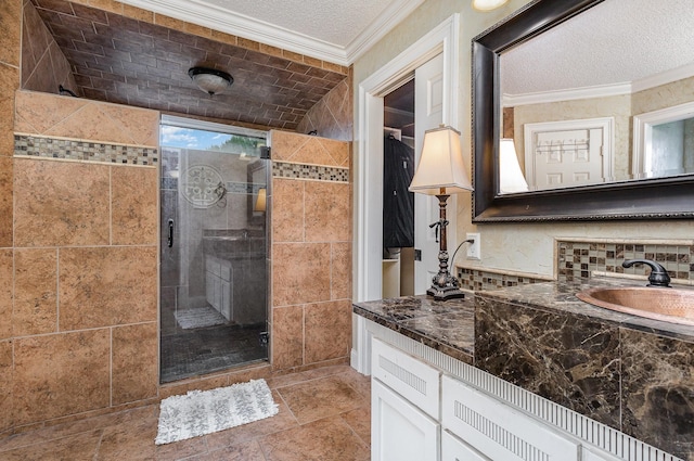3313 Conlin Dr, Rowlett, TX 75088 - bathroom with a shower stall, ornamental molding, vanity, and a textured ceiling