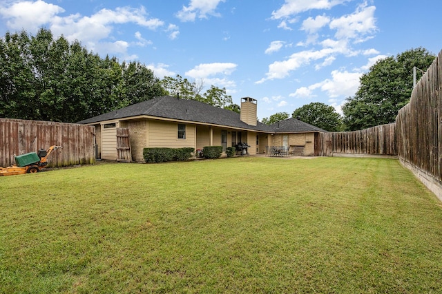 3313 Conlin Dr, Rowlett, TX 75088 - back of property featuring brick siding, a chimney, and a patio area