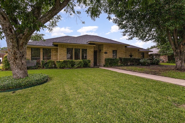 3313 Conlin Dr, Rowlett, TX 75088 - view of front of home featuring brick siding, a front yard, and a shingled roof