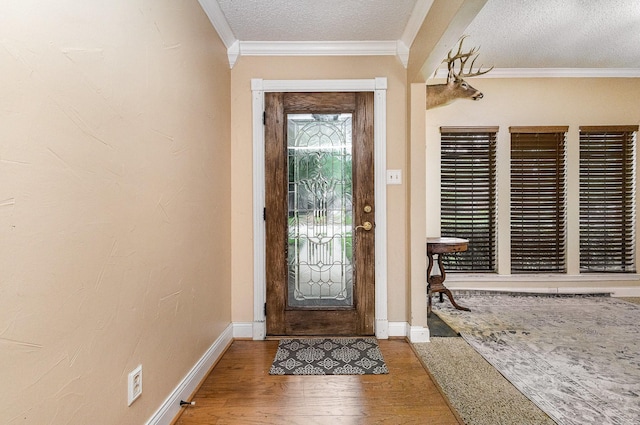 3313 Conlin Dr, Rowlett, TX 75088 - foyer entrance with wood finished floors, baseboards, ornamental molding, and a textured ceiling