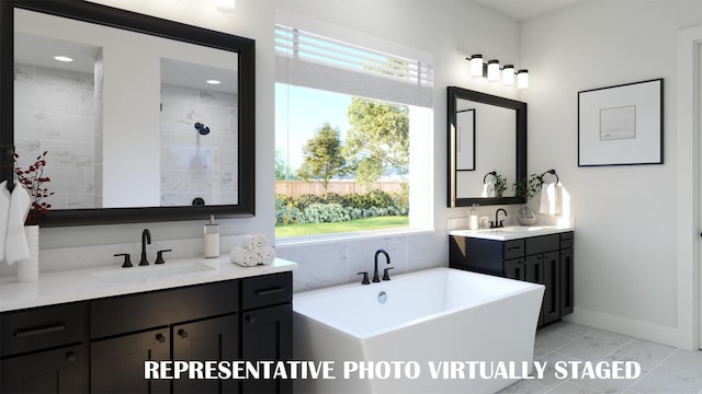 990 Stargrass Dr, Allen, TX 75013 - bathroom with a freestanding tub, healthy amount of natural light, marble look tile flooring, and two vanities