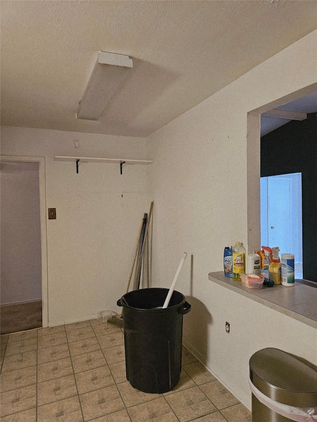 1231 Ravina Dr, Garland, TX 75041 - interior space with light tile patterned flooring and a textured ceiling