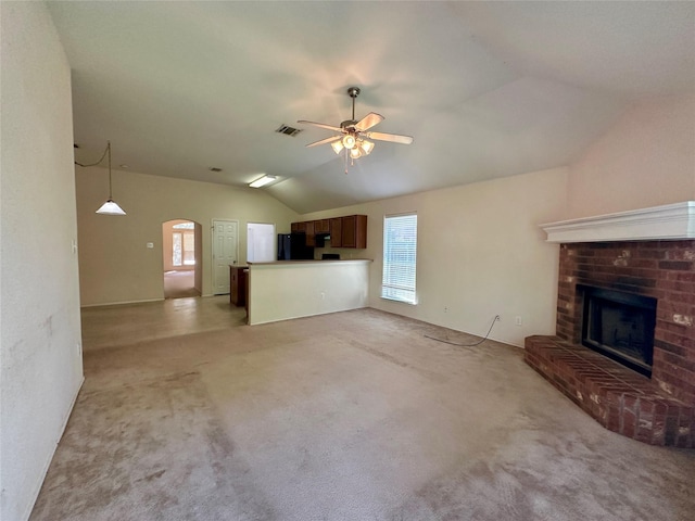 4821 Topaz Ln, Granbury, TX 76049 - unfurnished living room with lofted ceiling, healthy amount of natural light, arched walkways, a fireplace, and a ceiling fan