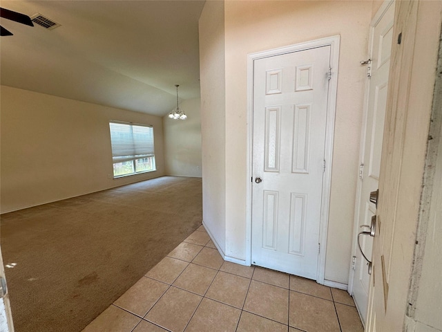 4821 Topaz Ln, Granbury, TX 76049 - hallway with light colored carpet, a chandelier, light tile patterned floors, and lofted ceiling