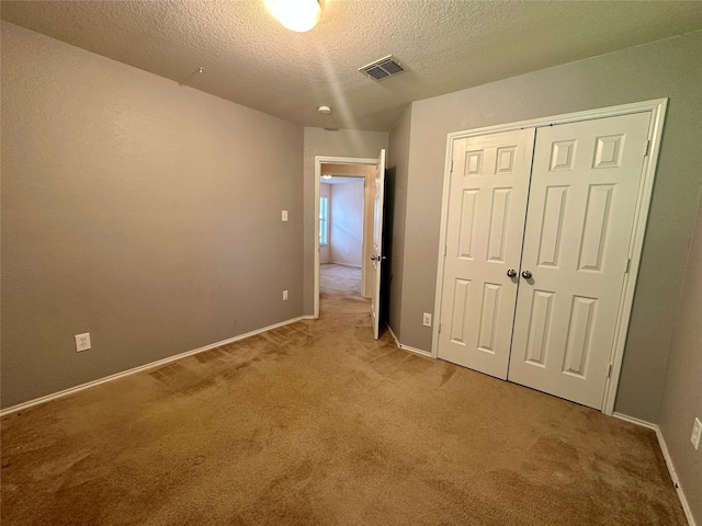 4821 Topaz Ln, Granbury, TX 76049 - unfurnished bedroom with carpet flooring, a textured ceiling, a closet, and baseboards