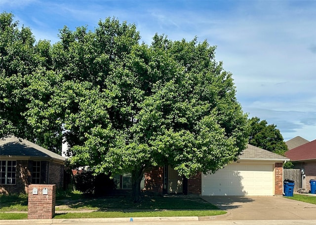 4821 Topaz Ln, Granbury, TX 76049 - view of front of property featuring brick siding, an attached garage, and concrete driveway