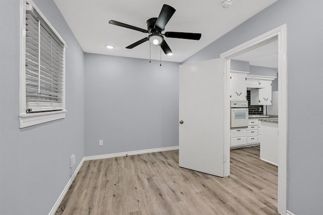110 W Moore St, Sherman, TX 75090 - unfurnished room featuring light wood finished floors, ceiling fan, baseboards, and a smoke detector